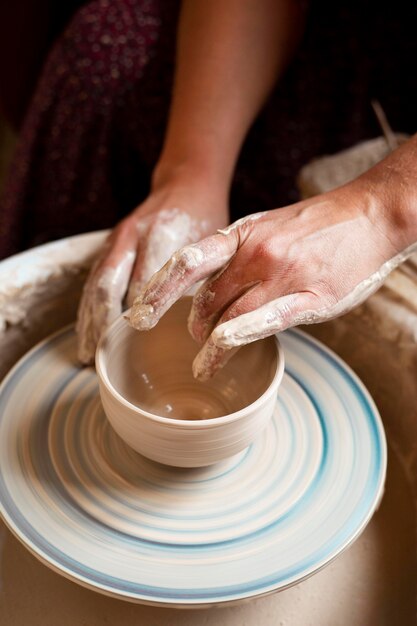 Person modeling in clay on a potter's wheel