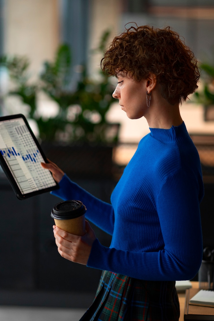 Free Photo person in the office analyzing and checking finance graphs