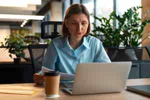 Free photo person in the office analyzing and checking finance graphs