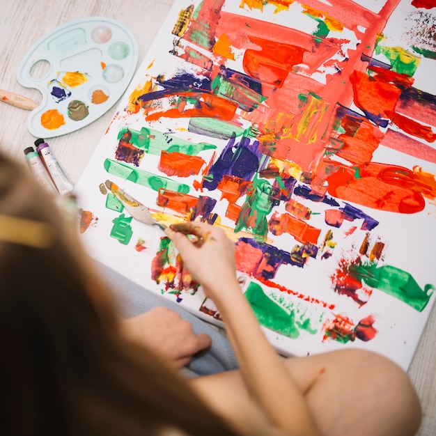 Person painting with gouache on big canvas