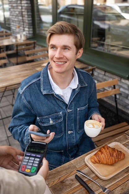 Person paying using nfc technology