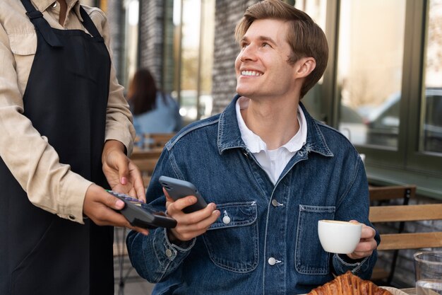 Person paying using nfc technology