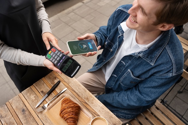 Person paying using nfc technology