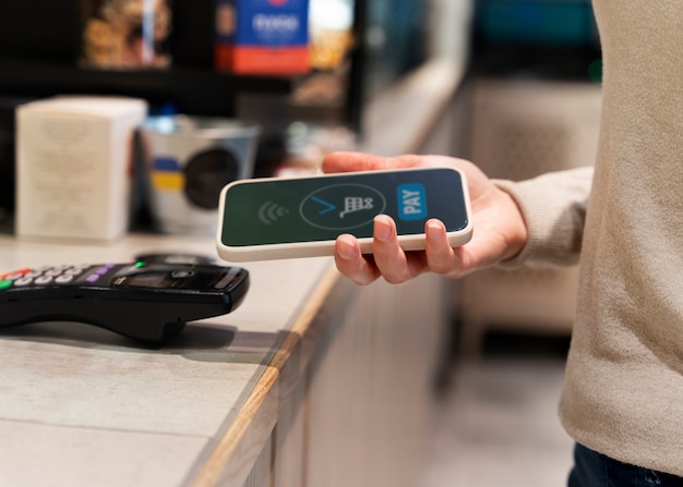 Person paying using nfc technology