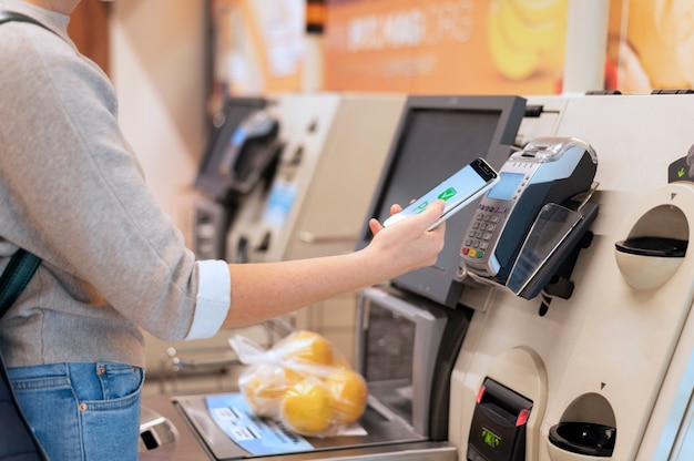 Person paying with its smartphone wallet app