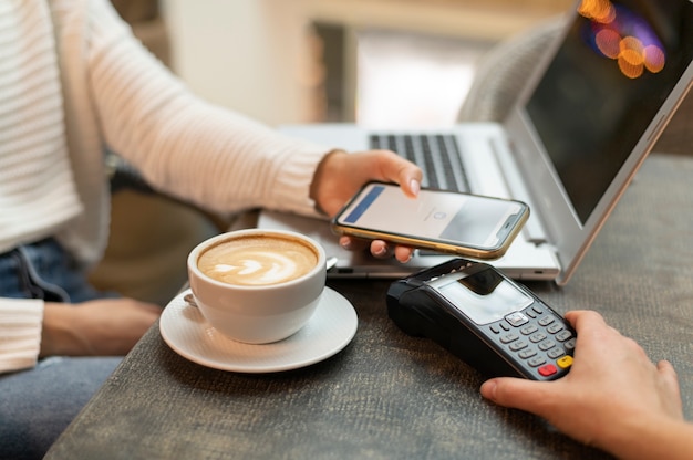 Person paying with its smartphone wallet app