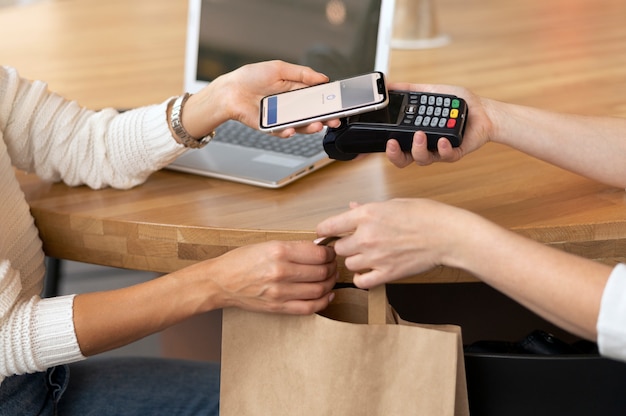 Person paying with its smartphone wallet app