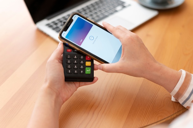 Person paying with its smartphone wallet app