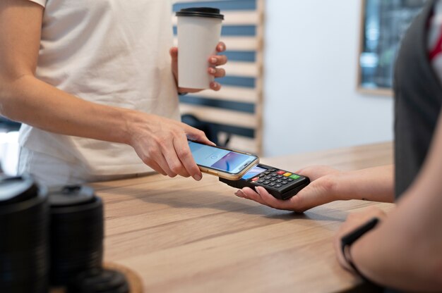 Person paying with its smartphone wallet app