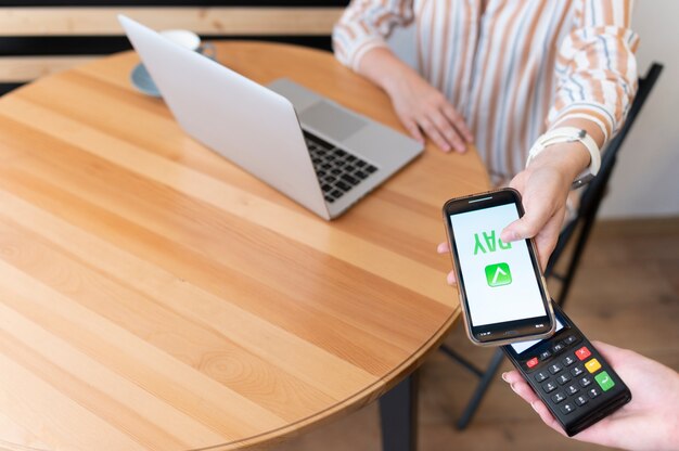 Person paying with its smartphone wallet app