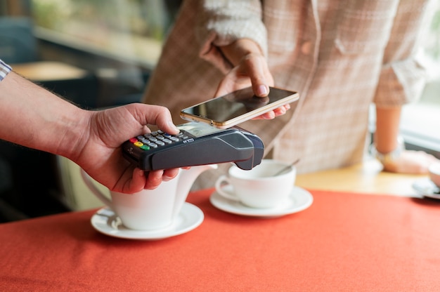 Person paying with its smartphone wallet app