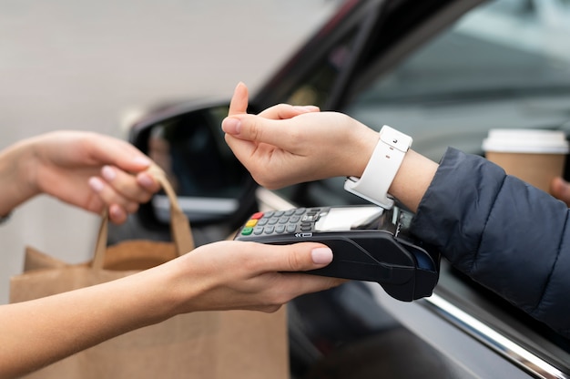 Person paying with its smartwatch wallet app