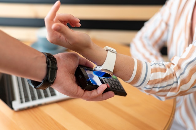 Person paying with its smartwatch wallet app