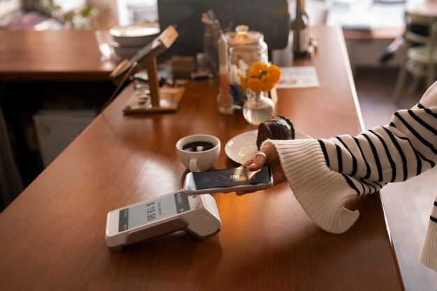 Person paying with nfc technology at a restaurant