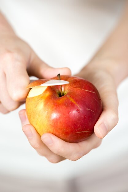 Person peeling an apple