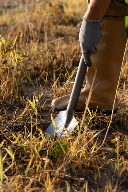 Free photo person planting tree on the countryside