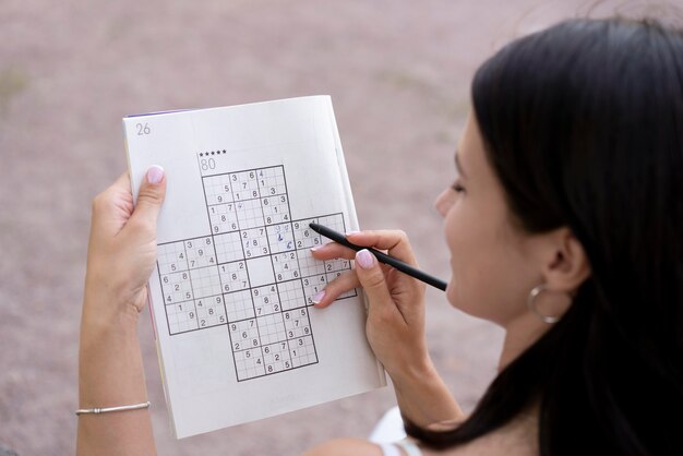 Person playing a sudoku game alone