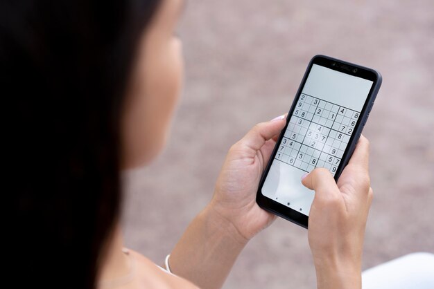 Person playing a sudoku game on a smartphone