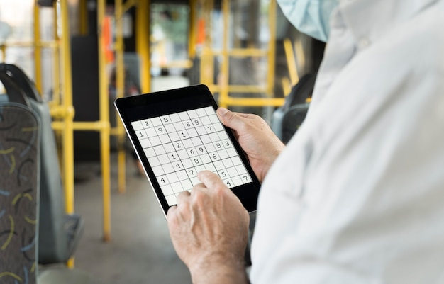 Person playing a sudoku game on a tablet