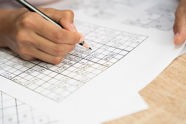 Person playing a sudoku game