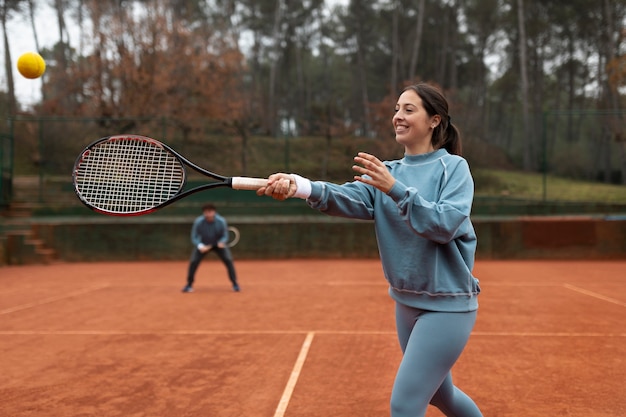 Person playing tennis game in winter time