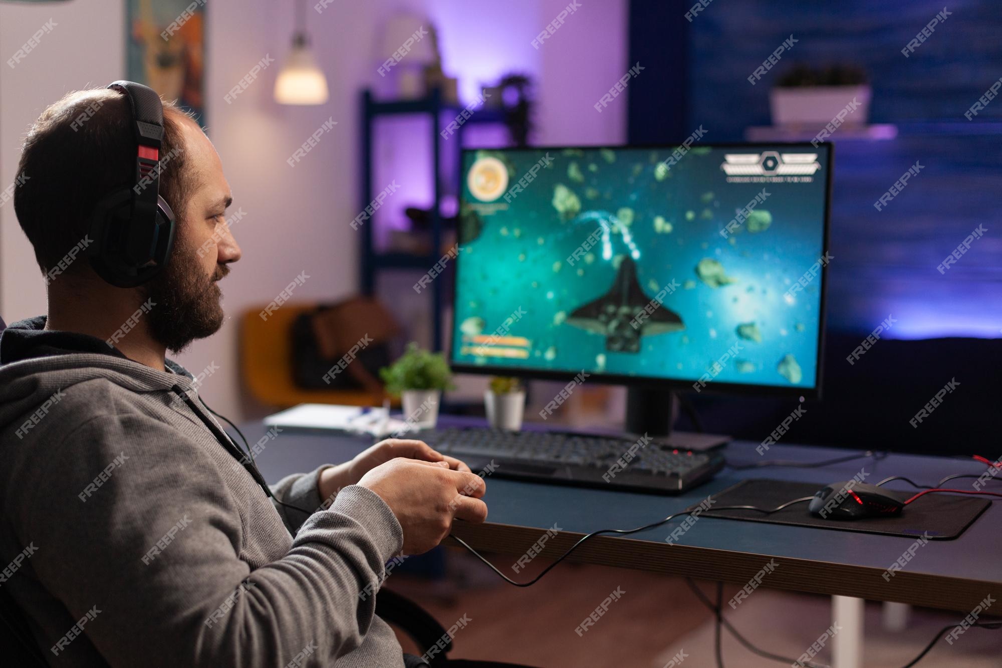 Free Photo  Gamer using controller to play online video games on computer.  man playing game with joystick and headphones in front of monitor. player  having gaming equipment, doing fun activity.