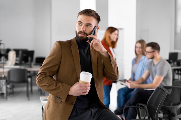 Person posing next to coworkers