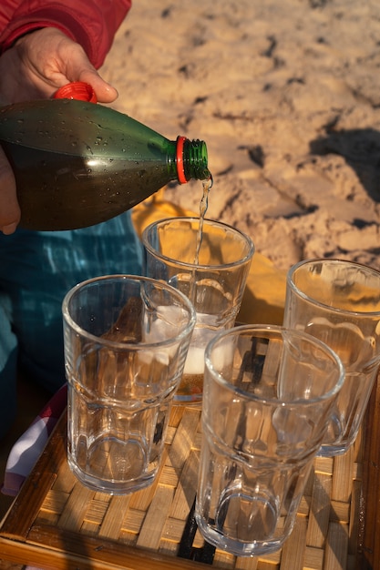 person-pouring-guarana-drink-glass-from-bottle_23-2150765620.jpg