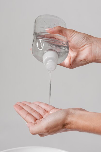 Person pouring hand sanitizer