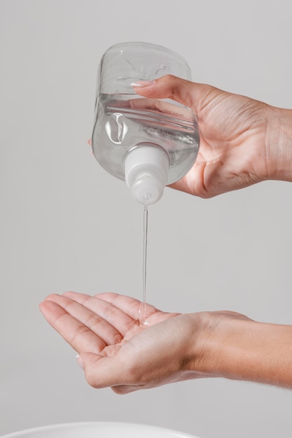 Person pouring hand sanitizer