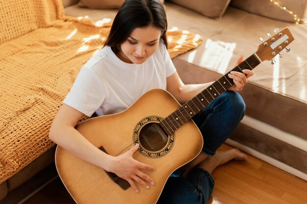 Free photo person practicing music alone at home