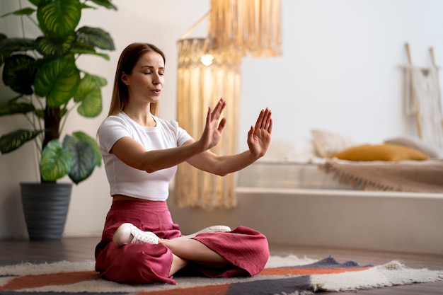 Free photo person practicing tai chi indoors