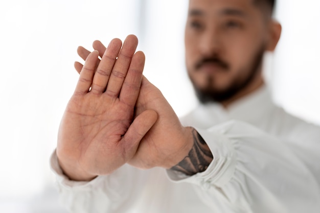 Free photo person practicing tai chi indoors