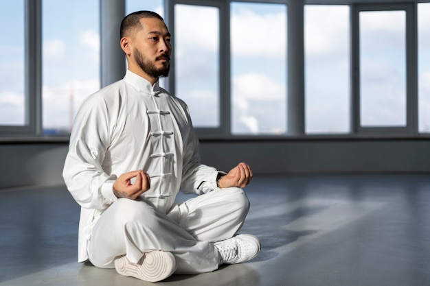 person practicing tai chi indoors