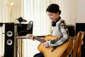 Free photo person producing music in home studio