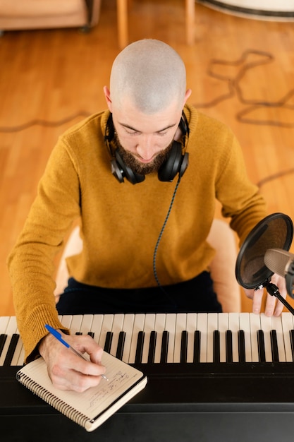 Free photo person producing music at home