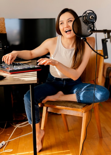 Free photo person producing music at home