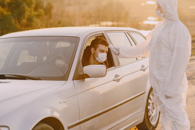 Person in a protective suit checks the temperature