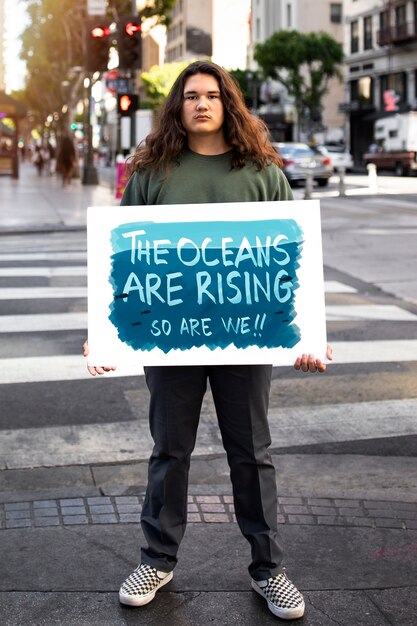 person protesting with placard for world environment day outdoors