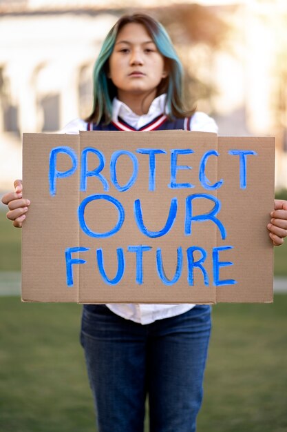 person protesting with placard for world environment day outdoors
