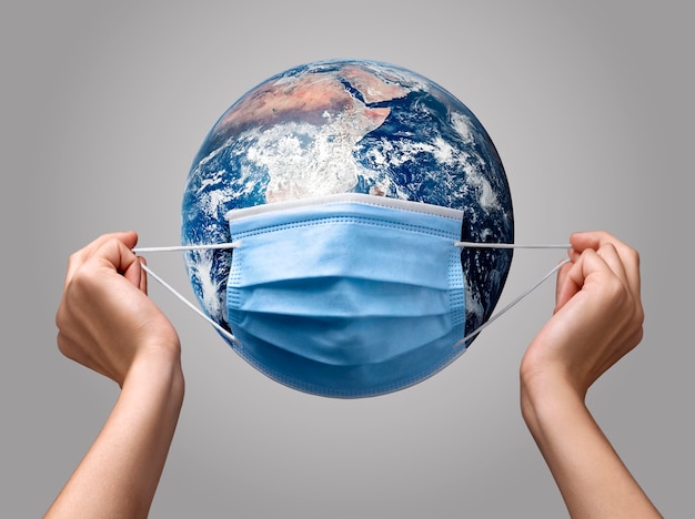 Person putting a medical mask on earth