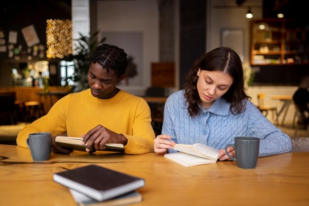 Person reading a book in a cafe