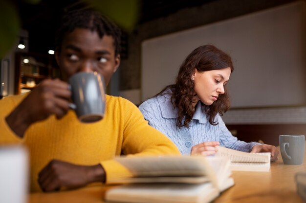 Person reading a book in a cafe