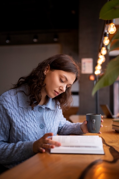 Person reading a book in a cafe