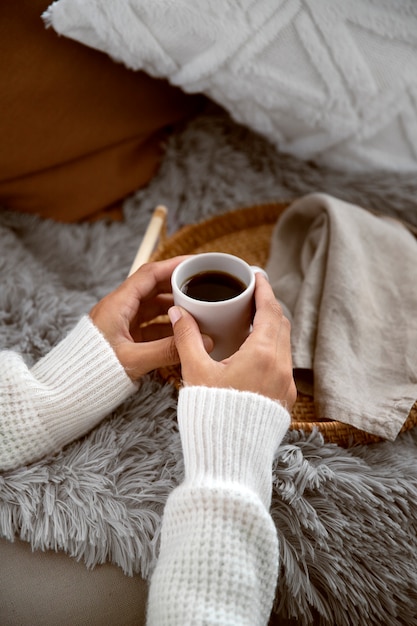 Person relaxing on winter with cozy clothing