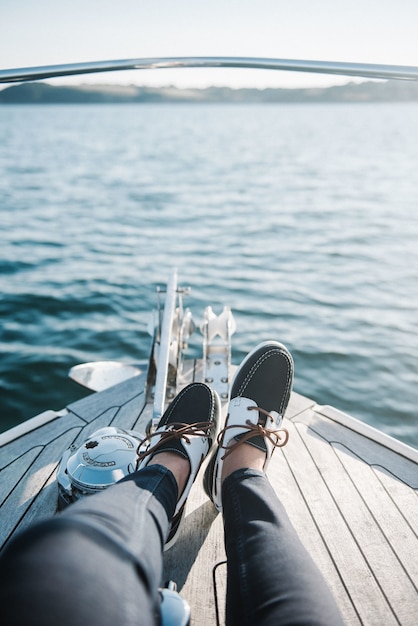 Person's feet on the boat sailing on the sea during daytime