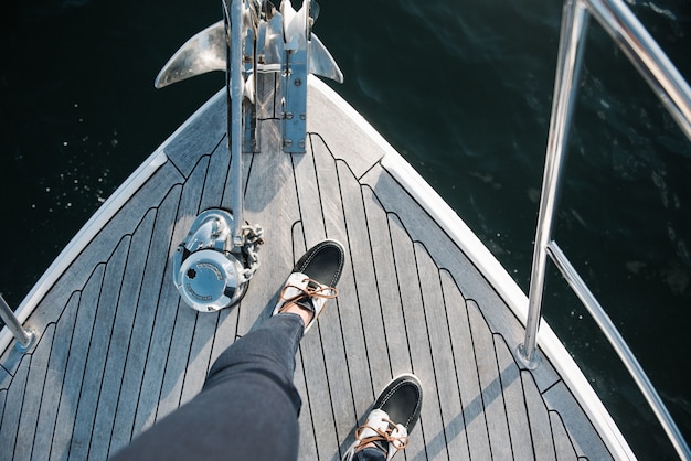 Person's feet on the boat sailing on the sea during daytime