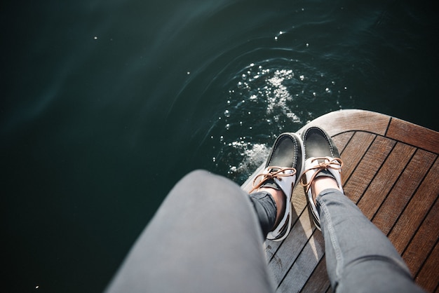 Person's feet on the boat sailing on the sea during daytime