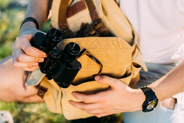 Person's hand holding binocular