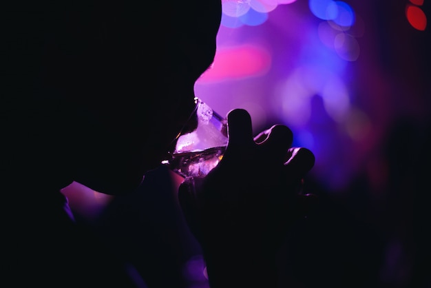 person silhouette drinking in a modern bar